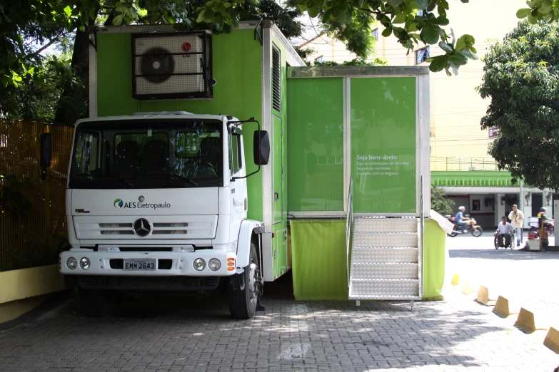 a white truck parked in front of a green house