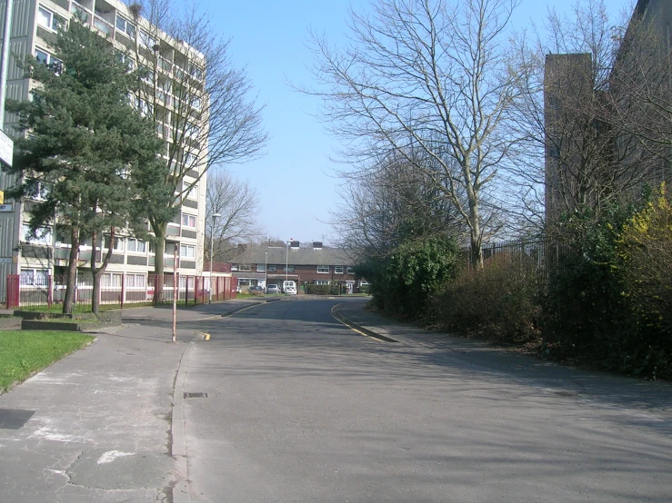 a empty street is pictured at the end of an almost deserted street