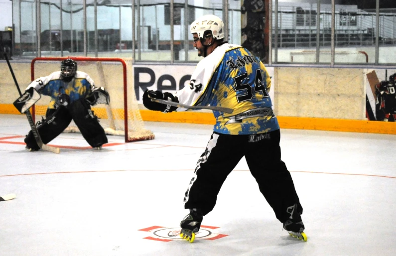 some hockey players with pads and gloves on