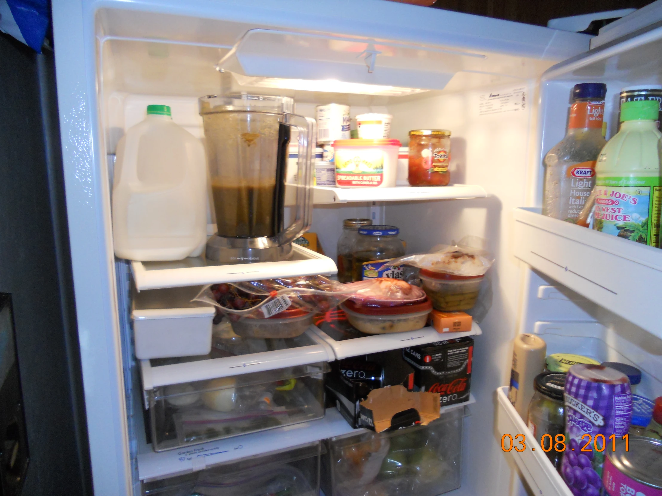 the fridge is filled with some food and drinks