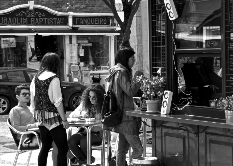 three women sitting at an outdoor cafe