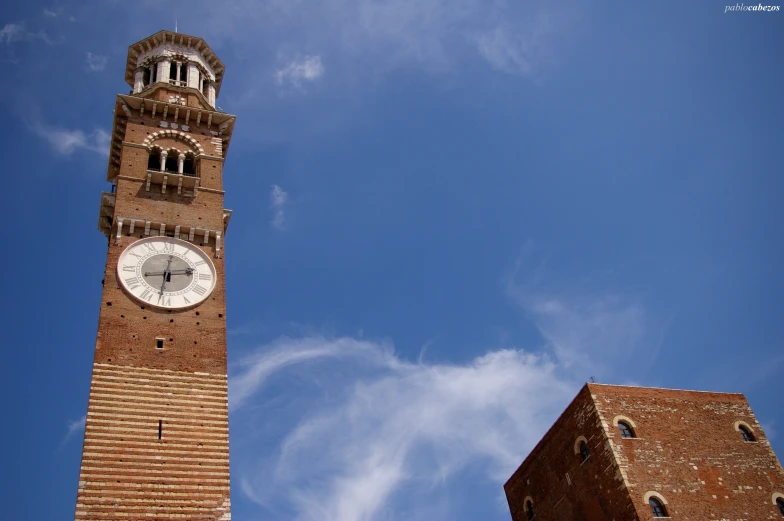 a tall clock tower towering over a brick building