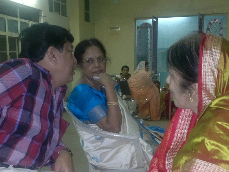 a man is talking to two women who are both looking at each other