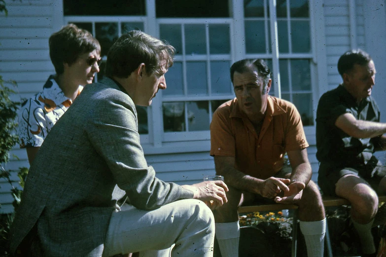 a group of men sitting on top of a bench