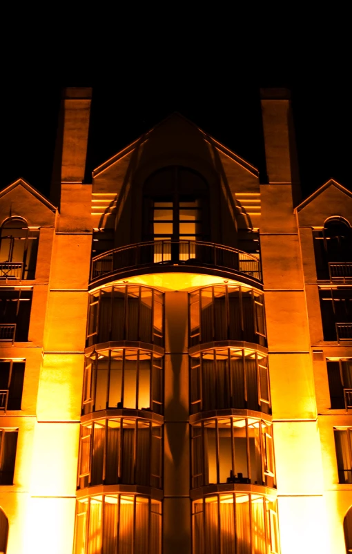 large tan building with light up windows lit from under