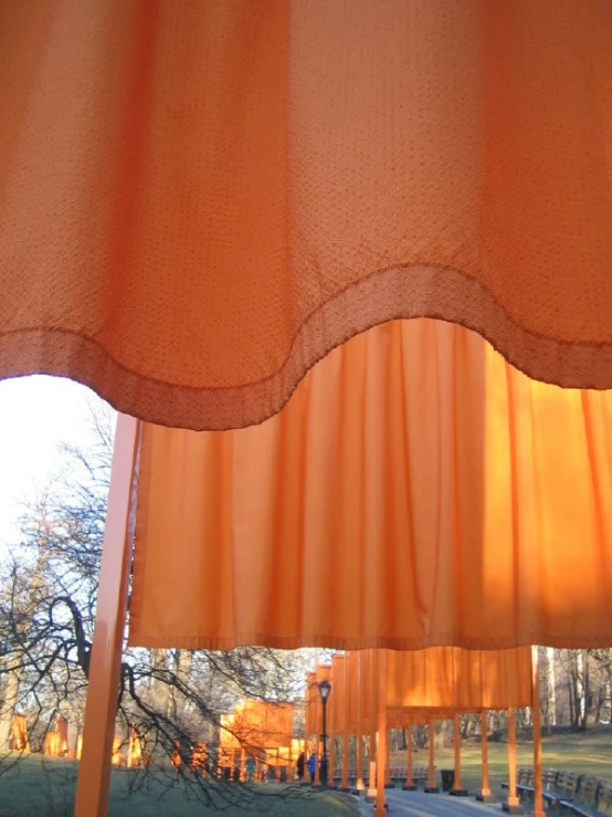 a orange curtain that is opened to let in light