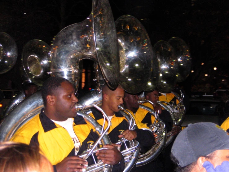 a band marching with giant metallic balls on their back