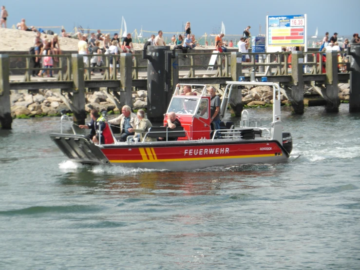 a group of people riding in the back of a small boat