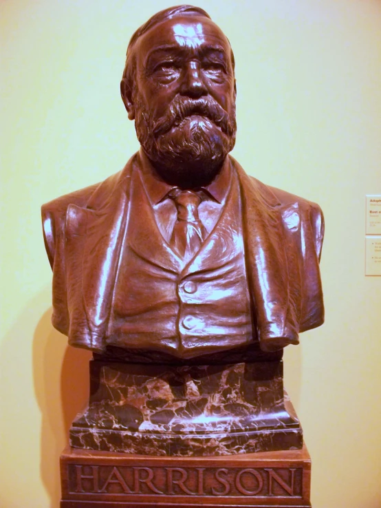 this bust of a man wearing a suit has a plaque on his chest