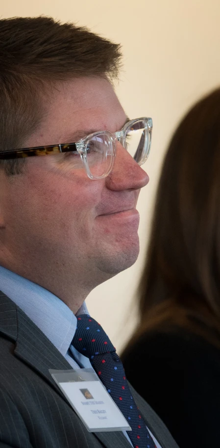 a man wearing a suit and tie at an event