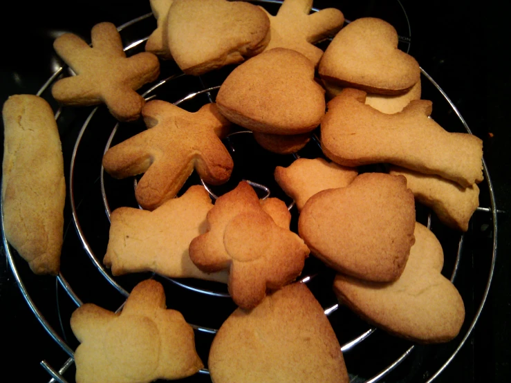 heart shaped cookies sitting on a wire rack