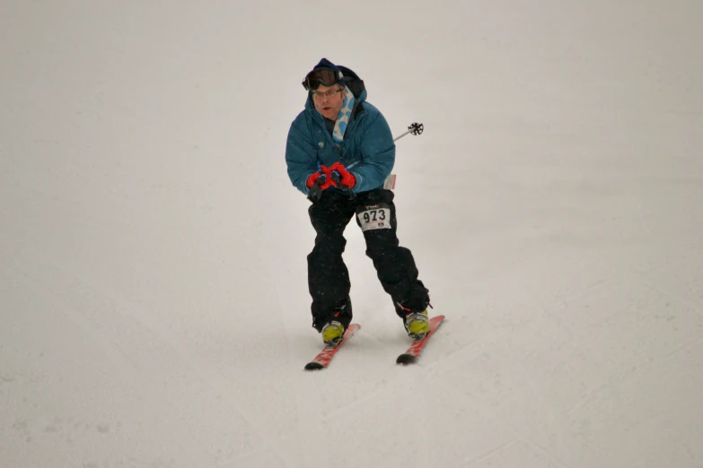 a young skier riding on snow covered hill