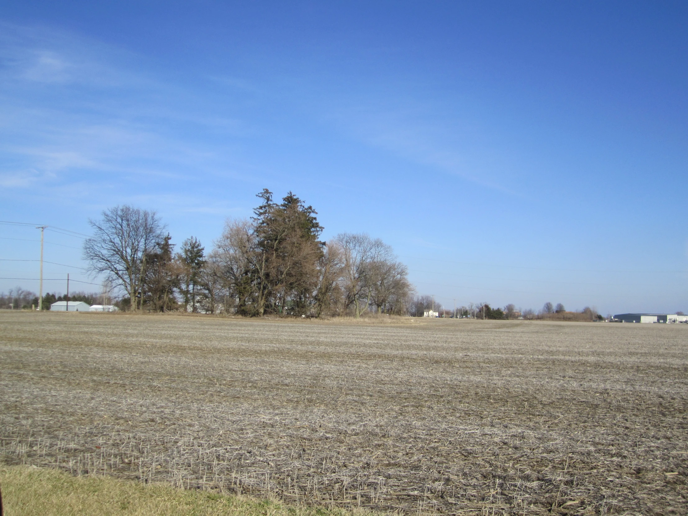 the view of a plowed field in front of a blue sky