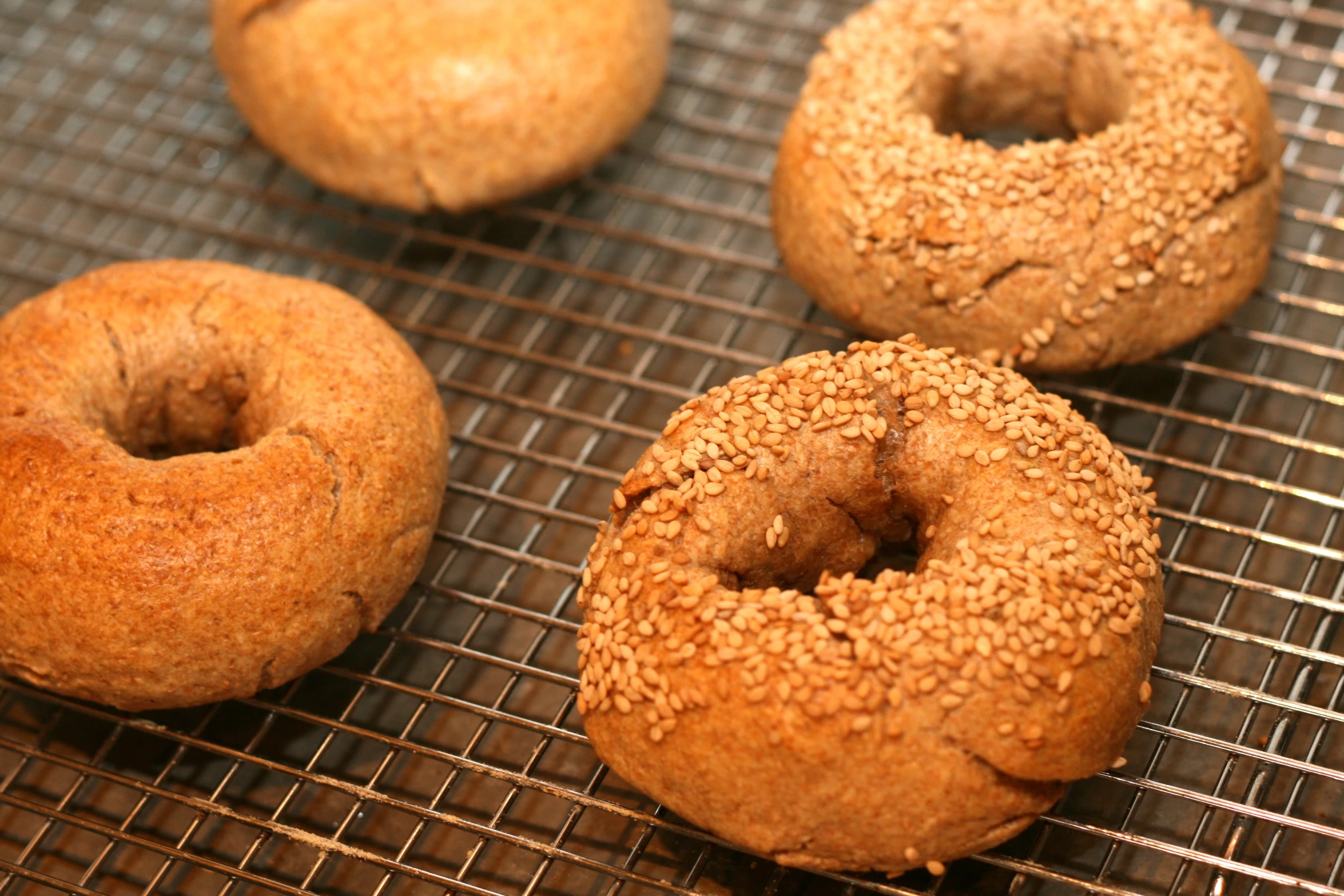 a bunch of donuts cooling on a rack