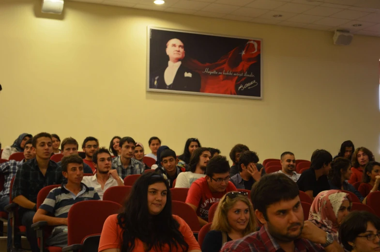 a large group of people sitting in chairs