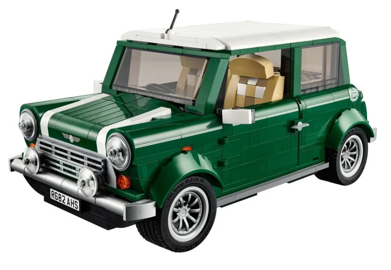 a toy model of a green land rover with a beige roof