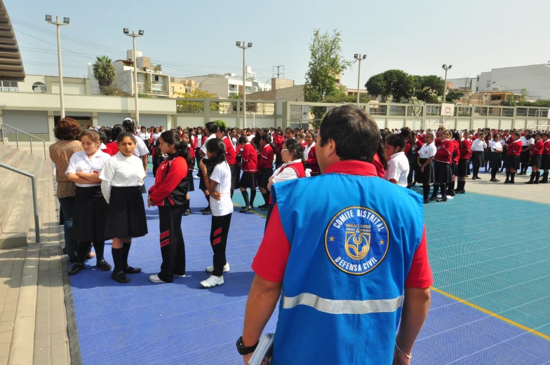 people standing in line wearing uniforms in a stadium