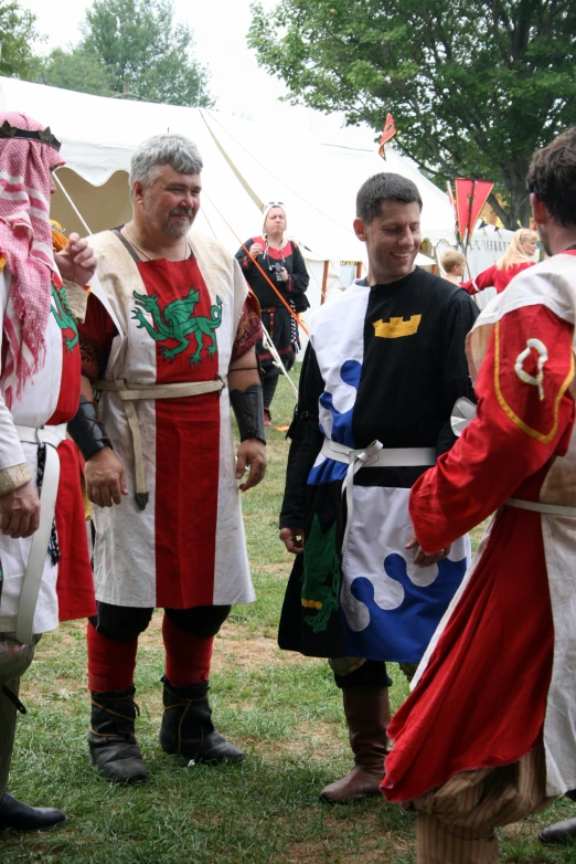 several men in costume, one man is holding a staff