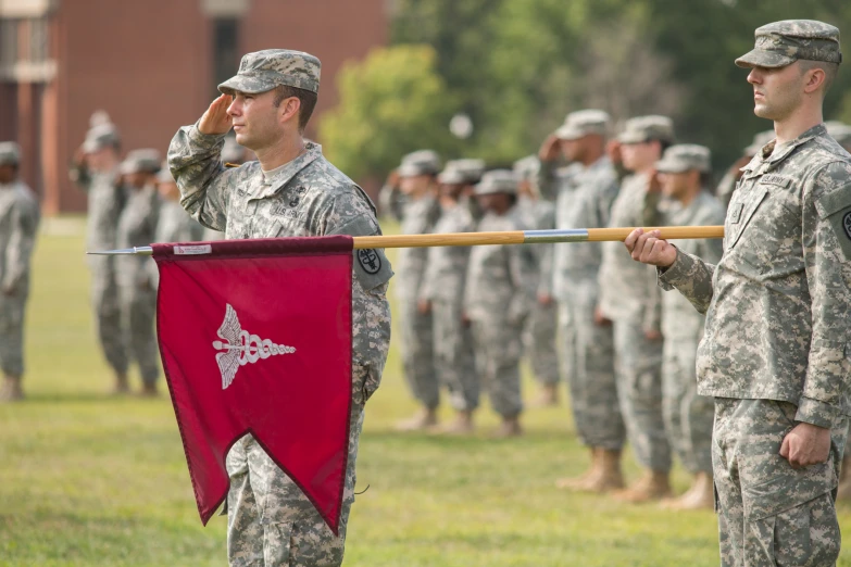 a group of people in uniform holding flags