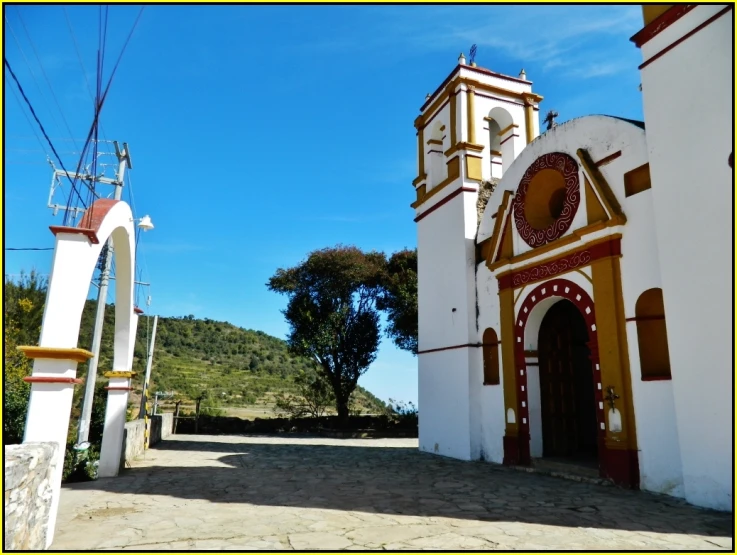 a small church in a small town next to some trees