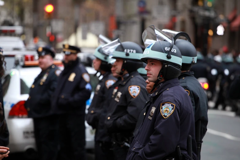 police standing in a row with their helmets off