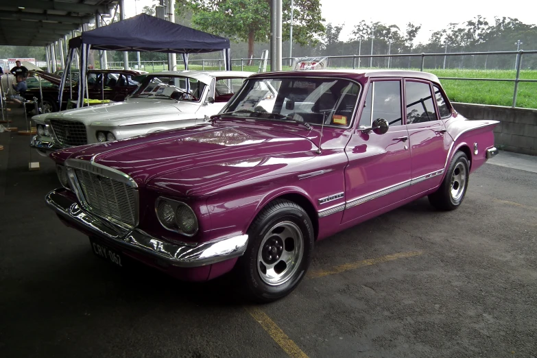 an older model car in the parking lot