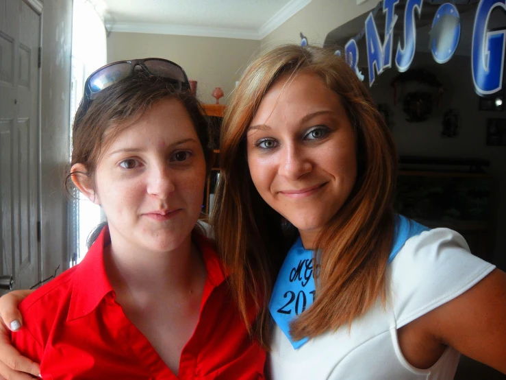 a woman is standing next to another woman in a room