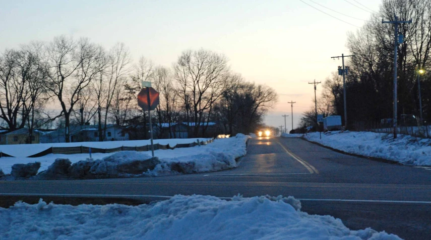 the car is headed down the road on a cold day