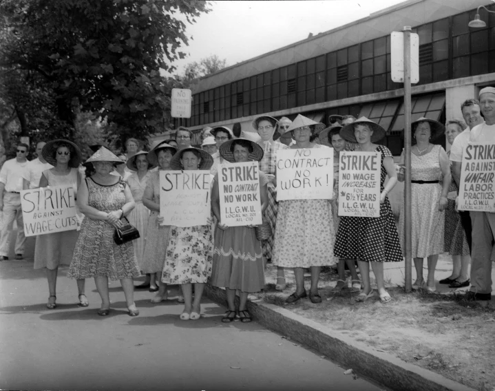 an old po of women protesting strike strike back and protest outside of a building