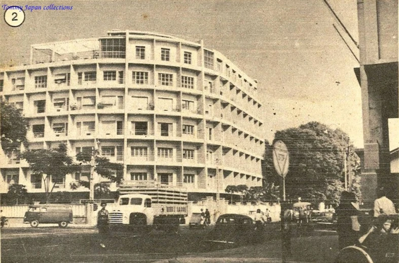 an old picture of a bus in front of a building