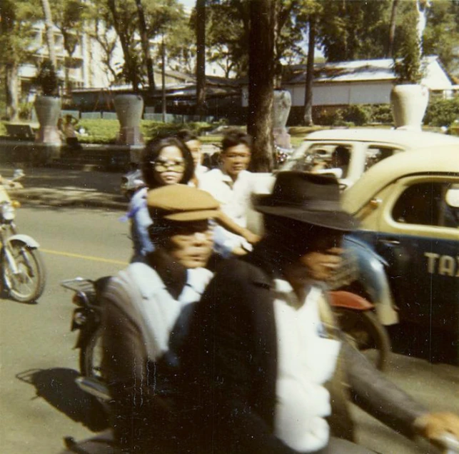 a couple of people sitting on the back of a car