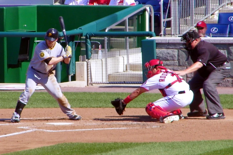 a baseball player holding a bat next to home plate