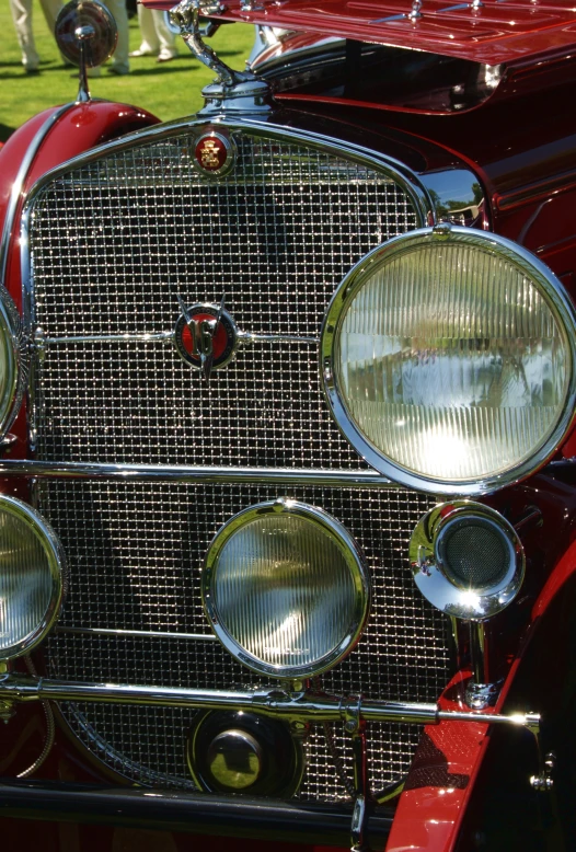 the front end of a classic car in a showroom