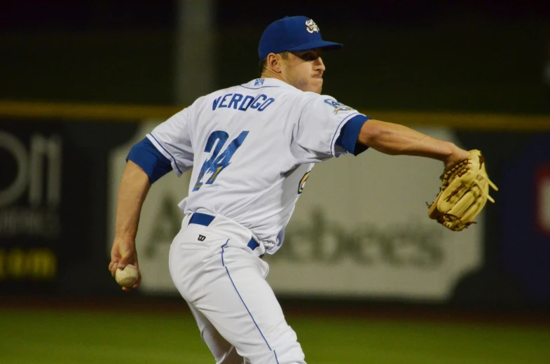 a baseball player throwing a baseball on a field