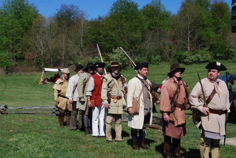 group of men in period costume standing next to each other