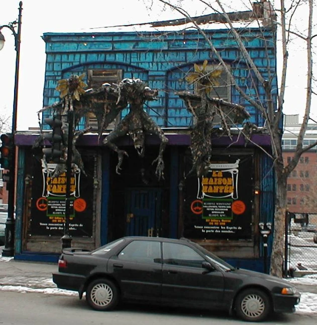 car parked in front of a small store front