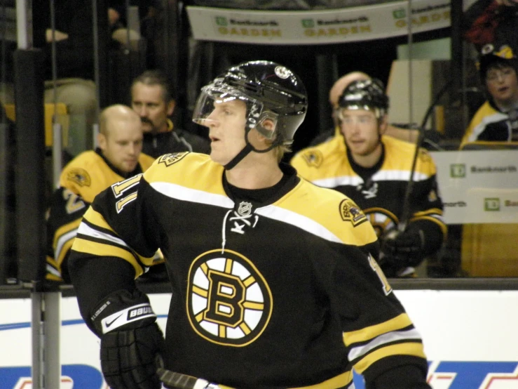 a hockey player in uniform standing on the ice