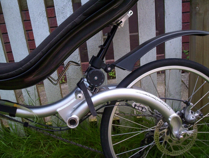 the front wheel of a bicycle parked in front of a house