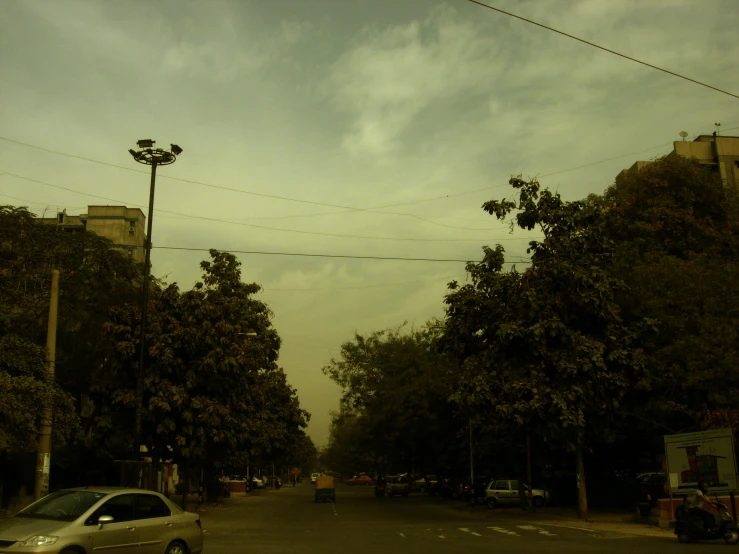 the back side of a car drives down an empty street