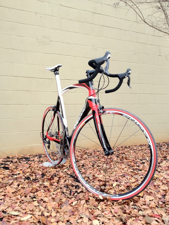 a bicycle parked in front of a cement wall