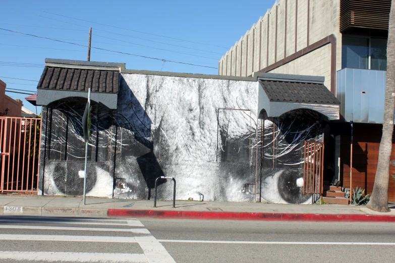 a building with large artistic mural next to it