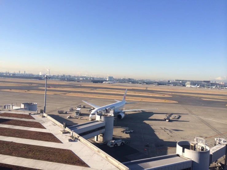 an air port run way with several airplanes parked