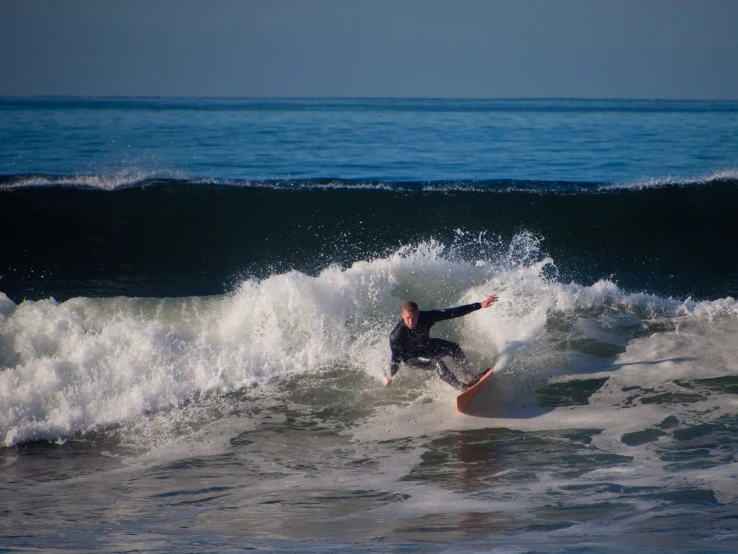 a man that is riding a surfboard in the water