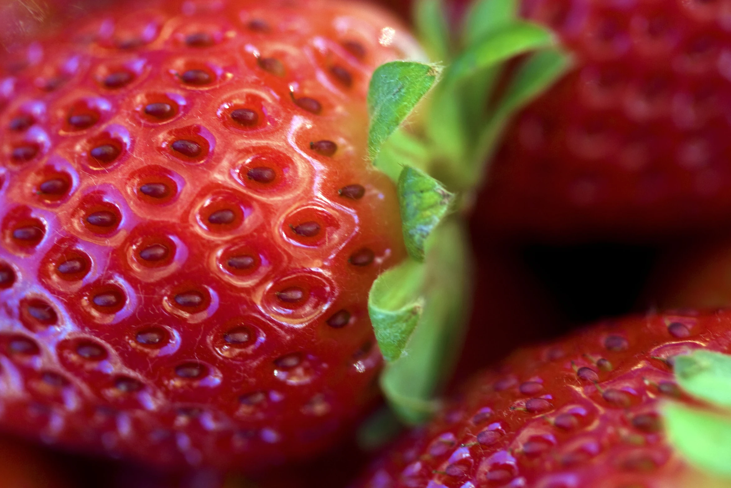 the inside of red strawberries with small green leaves