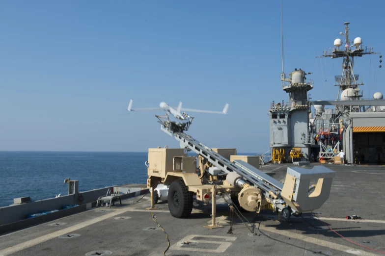 a military truck is on an aircraft carrier