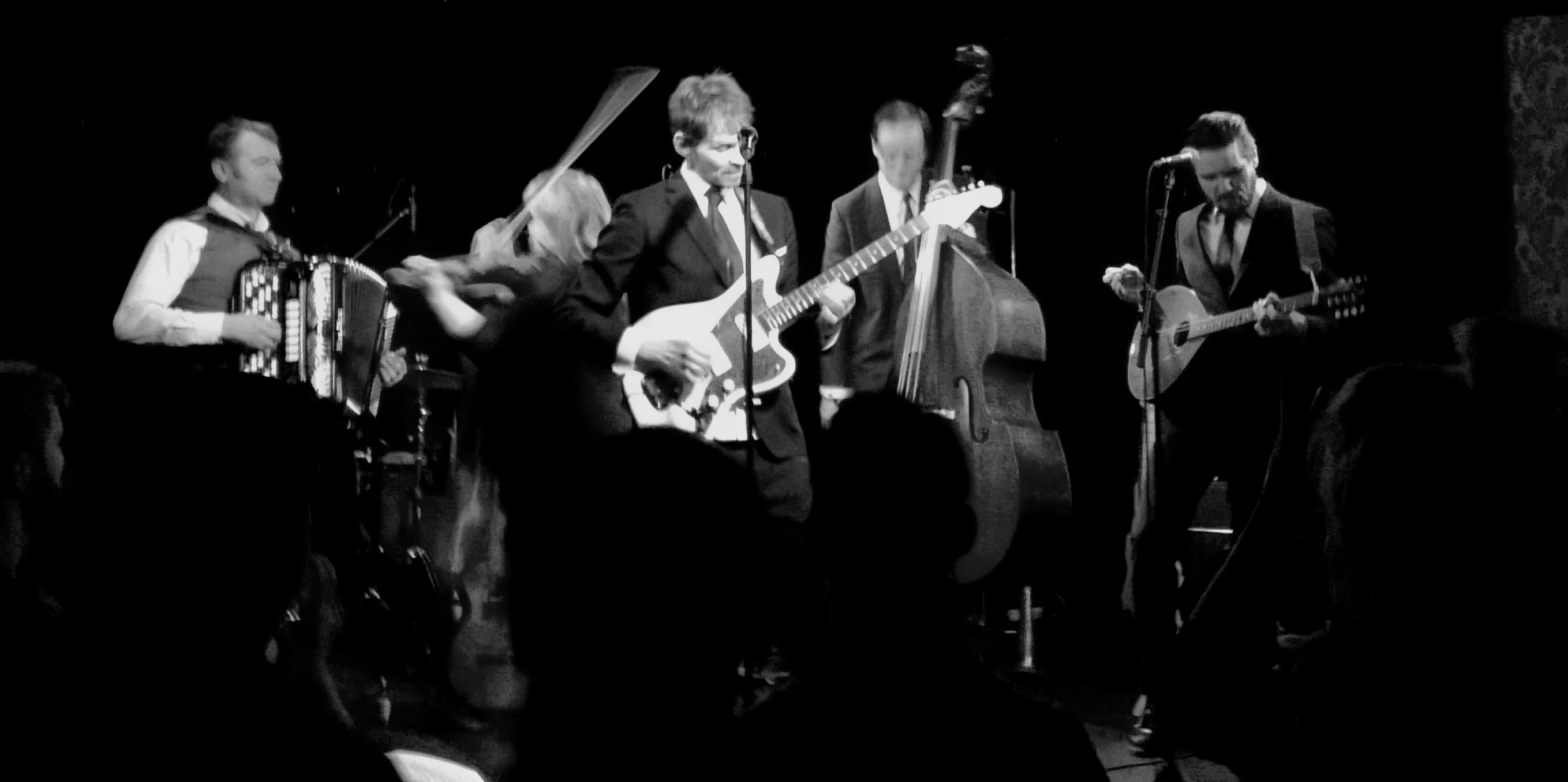 black and white pograph of band with instruments