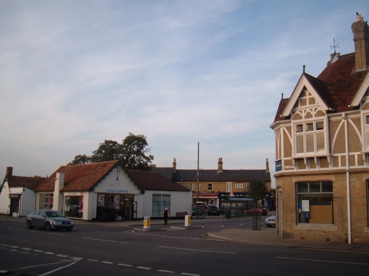 a white building is standing in a street corner