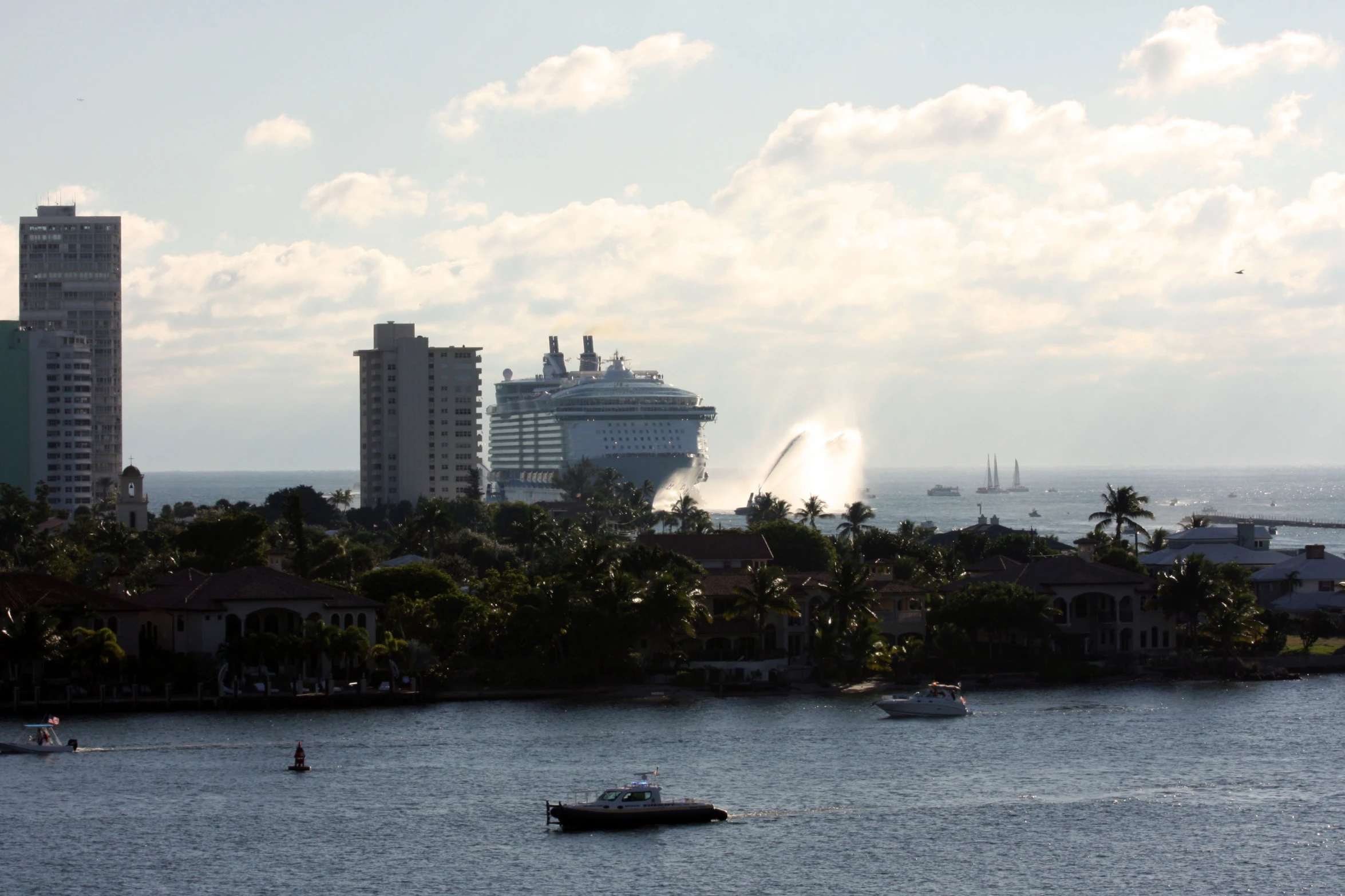 a boat is moving on the water with buildings and water spewing from it