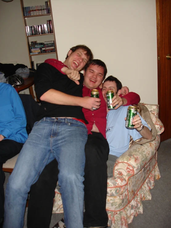 three friends having fun together while drinking beers