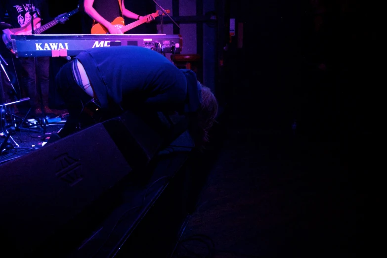 there are three people playing instruments on the stage